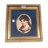 A Continental porcelain oval plaque, 20th century, depicting a bust of a young lady, 17.