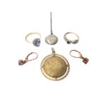 Two 9ct gold and gem set rings, a gold circular pendant in a Byzantine inspired design,