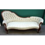 A Victorian rosewood framed spoon back chaise longue, with serpentine seat and scroll supports,