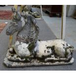 A pair of reconstituted stone figures of recumbent horses, 90cm wide x 60cm high, (2).