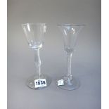 Two airtwist wine glasses, mid 18th century, the first with rounded funnel bowl and knopped stem,