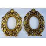 A pair of 18th century style acanthus carved gilt frames, each with oval aperture and shell crest,