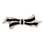 A two colour gold, diamond and black enamelled brooch, designed as a tied bow,