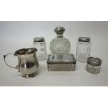 Silver and silver mounted wares, comprising; four glass toilet bottles and jars with silver covers,