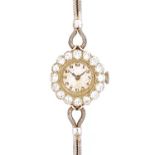 A lady's diamond set dress bracelet wristwatch, with a circular unsigned jewelled Swiss movement,