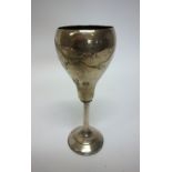 A Russian goblet engraved with spray motifs, raised on an associated loaded circular foot,
