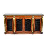 A William IV side cabinet In the manner of Marsh & Tatham, the marble top over four grille doors,