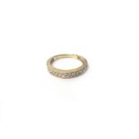 A 9ct gold and diamond set eleven stone half hoop eternity ring,
