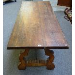 A 17th century style Spanish walnut refectory dining table, on open trestle supports,