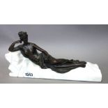 A Modern bronze classical female, semi-nude, reclining atop a naturalistic marble base (28.