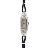A lady's platinum cased and diamond set dress wristwatch, with a jeweled lever movement,