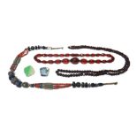 A single row necklace of graduated faceted garnet beads, two further bead necklaces,