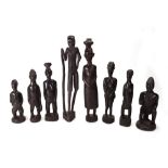 A group of eight African carved wood figures of tribal men and women, the largest 32cm high (8).