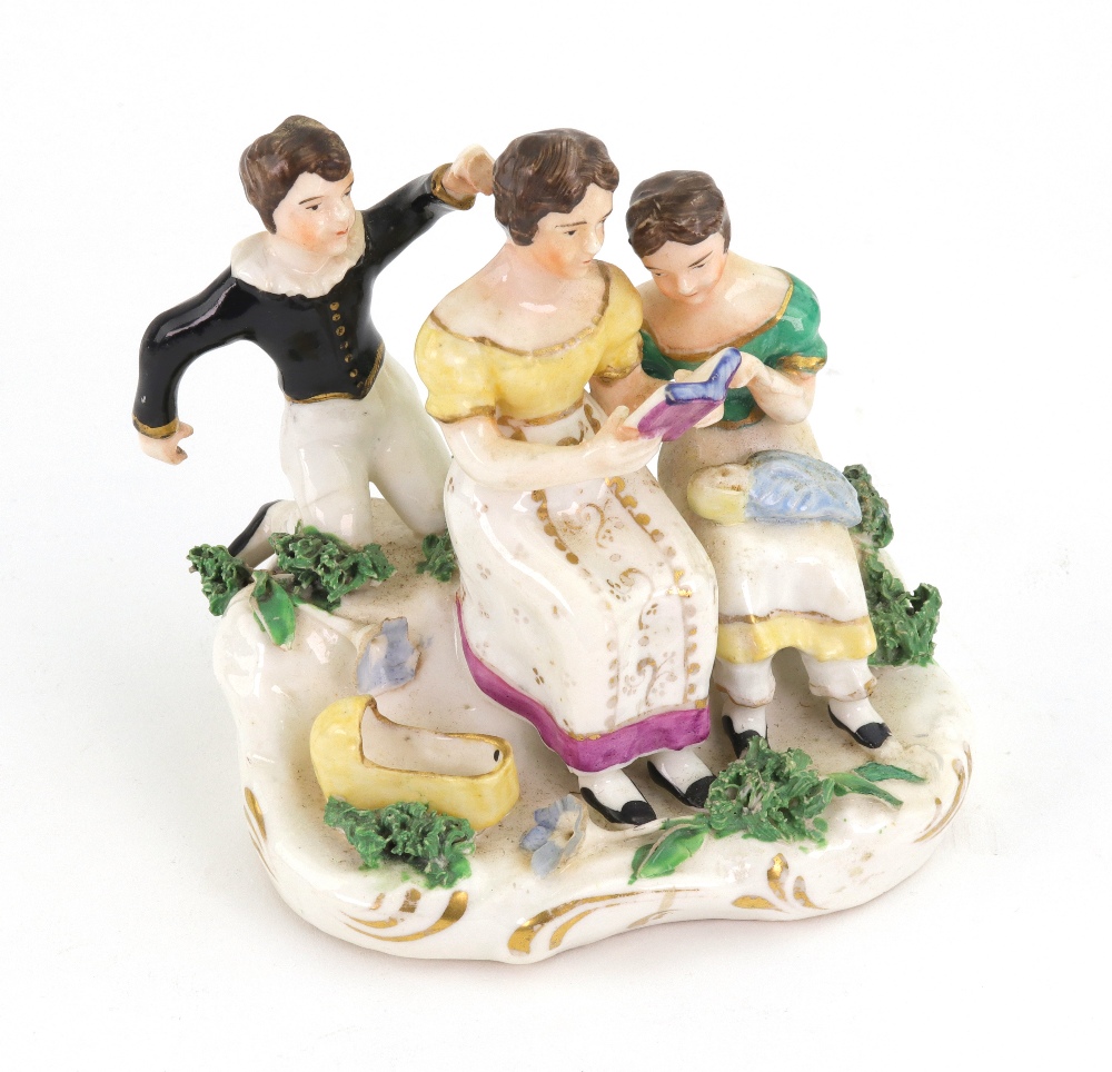 An English porcelain group, circa 1830, modelled as a mother holding an open book,