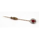 A ruby and diamond oval cluster stick pin,