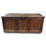 A late 17th century oak coffer, of panelled construction, with hinged top,