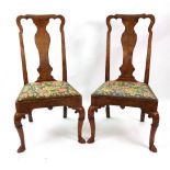 A pair of Queen Anne walnut single chairs, the shaped open backs with solid vase splats,