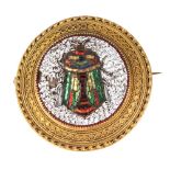 A Victorian gold and micromosaic round brooch, depicting a polychrome beetle on a white ground,