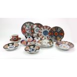 A group of nine Japanese Imari dishes, late 19th/20th century, each painted with typical designs,