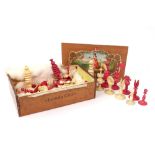 An English carved and turned ivory chess set, 19th century, one half stained red, the other natural,