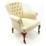 A reproduction button down upholstered armchair, of shaped outline,