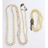 A long single row necklace of graduated cultured pearls, on a paste set clasp stamped '935',