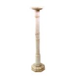 A white onyx marble pedestal, 20th century, with ringed cylindrical column, on an octagonal base,