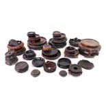 A large collection of Chinese and Japanese carved rosewood, hardwood and ebonised vase stands,