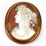 A Victorian carved shell cameo of a lady facing sinister with flowers in her hair,