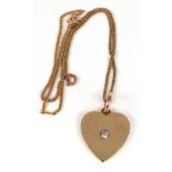 A gold and diamond heart shaped pendant on chain, early 20th century,