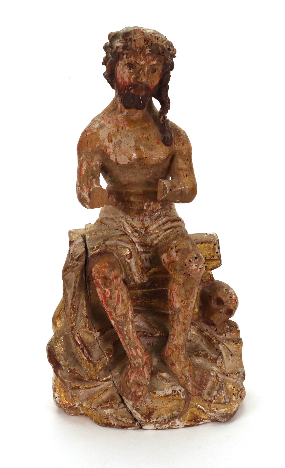 A carved gilded polychrome decorated seated figure of Christ, wearing the crown of thorns,
