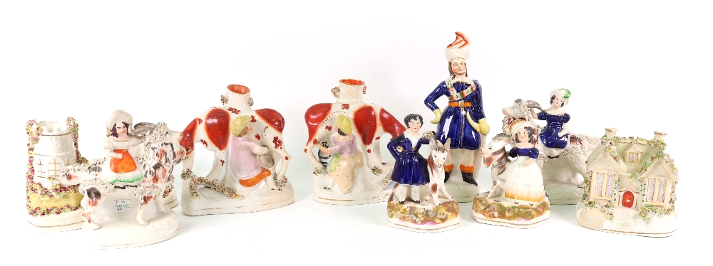 A collection of Victorian Staffordshire, a pair of cows and milkmaid spill vases, 15cm high,