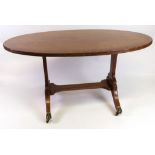A reproduction Regency style mahogany crossbanded boxwood strung low table, the oval top,