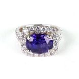 A purple sapphire and diamond cluster ring, the oval mixed-cut sapphire approx. 3.