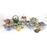 A group of fifteen Japanese and Chinese teapots and eleven covers, various dates,
