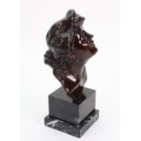 A bronze bust of a young woman, 20th century, her head raised,