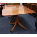 A reproduction Regency style mahogany dining table, the reeded edge top with two extra leaves,