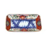 A Japanese Imari rectangular dish, Meiji period, the centre painted with bamboo,