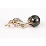 A South Sea black tinted cultured pearl and yellow metal brooch, the bead measuring 16.