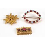 A Victorian gold and garnet necklace clasp, set with three oval mixed-cut stones, 4.