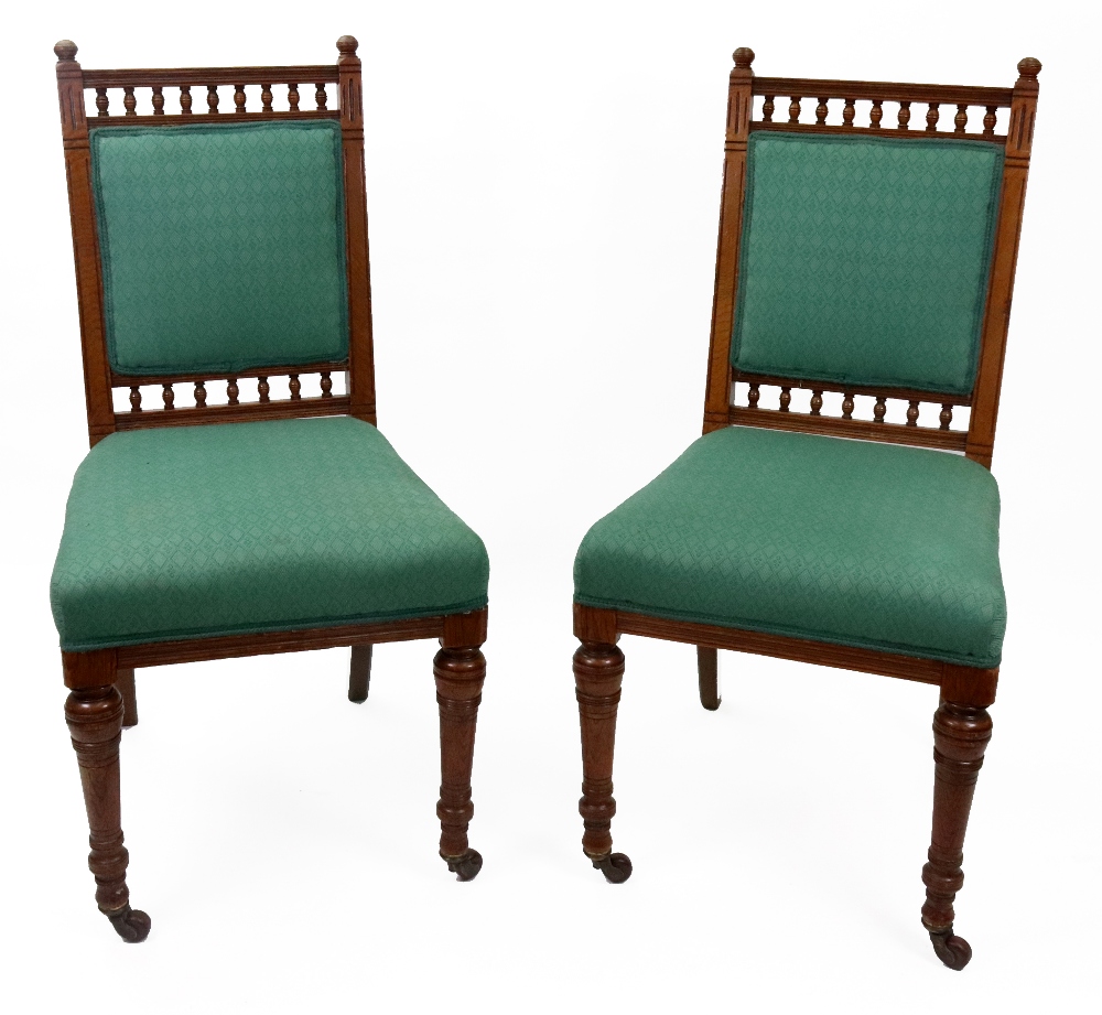 A set of six Edwardian oak dining chairs, with spindle filled galleries,