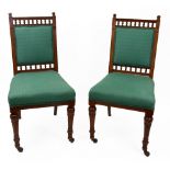 A set of six Edwardian oak dining chairs, with spindle filled galleries,