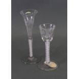 An opaque twist wine glass, circa 1765, the rounded funnel bowl engraved with a flower and sprig,