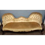 A Victorian carved rosewood frame double spoon back sofa, button down upholstered,