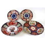 A Japanese Imari dish, Meiji period, painted in the centre with a vase of flowers,
