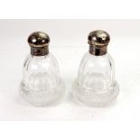 A pair of Edwardian silver mounted facet and diamond cut glass perfume bottles, Wakely & Wheeler,