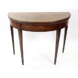 A George III mahogany tea table, with hinged demi lune fold over top, on square tapered legs,