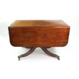 A Regency mahogany ebony banded breakfast table, with hinged drop leaves, two end drawers,