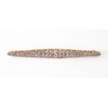 A pave diamond set bar brooch, early 20th century, of elongated lozenge outline,