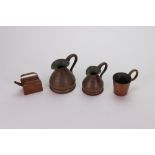 A graduated pair of copper haystack jugs, stamped 'Customs Cape of Good Hope, Gill' and '1/2 Gill',